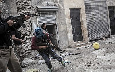 Syrian rebels confront government troops in Aleppo in late October (photo credit: AP/Narciso Contreras)