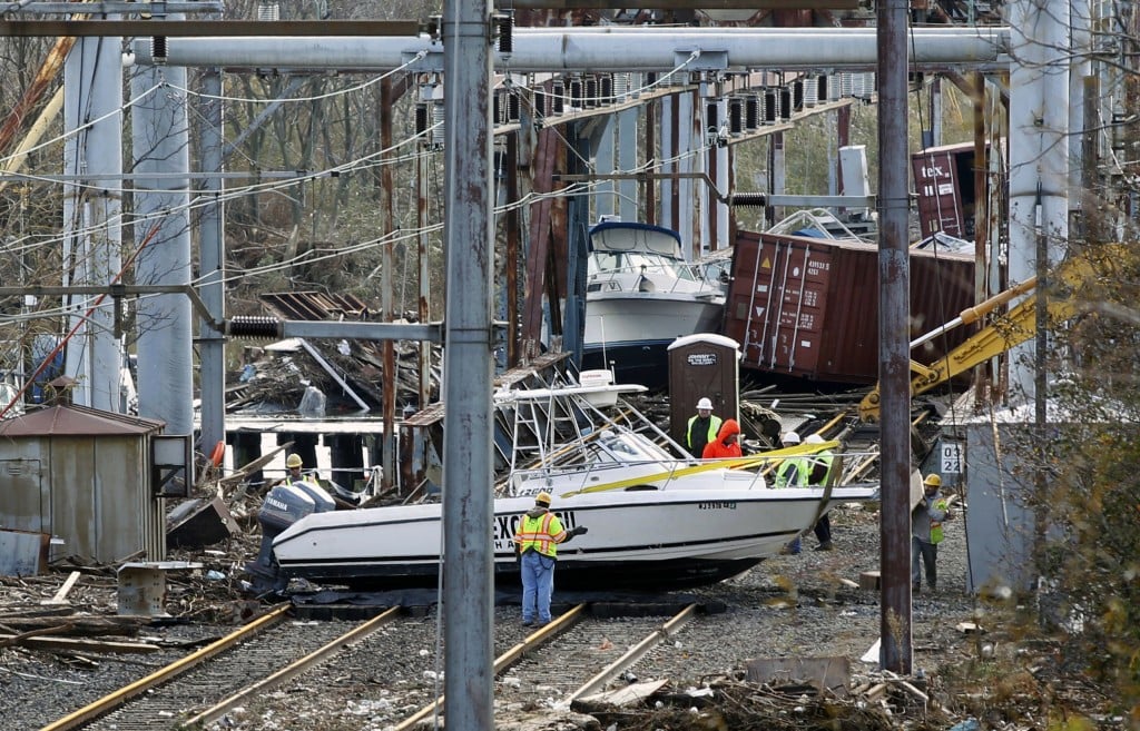 Workers try to clear boats and debris from the New Jersey Transit's Morgan draw bridge Wednesday, Oct. 31(photo credit: Mel Evans/ AP)