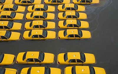 Taxis in a flooded parking lot in Hoboken, New Jersey. (AP/Charles Sykes)