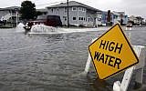 A car goes through high water in Ocean City, Maryland, as Hurricane Sandy bears down on the East Coast on Sunday (photo credit: AP/Alex Brandon)
