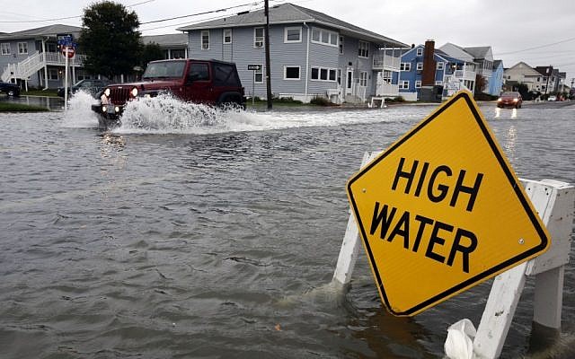 A car goes through high water in Ocean City, Maryland, as Hurricane Sandy bears down on the East Coast on Sunday (photo credit: AP/Alex Brandon) A car goes through high water in Ocean City, Maryland, as Hurricane Sandy bears down on the East Coast on Sunday (photo credit: AP/Alex Brandon)