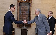 Syrian President Bashar Assad, left, greets UN and Arab League envoy Lakhdar Brahimi prior to their closed-door meeting in Damascus, Syria, Sunday Oct. 21 (photo credit: AP/SANA)