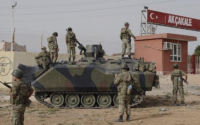 Turkish troops stationed at the border gate with Syria in Akcakale, Turkey (photo credit: AP)