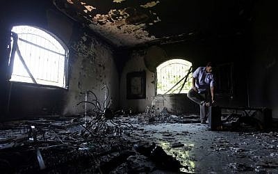 A Libyan man investigates the inside of the US Consulate in Benghazi, Libya, after an attack that killed four Americans, including Ambassador Chris Stevens on the night of Tuesday, Sept. 11, 2012 (photo credit: AP/Mohammad Hannon/File)