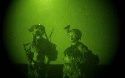 In this Oct. 28, 2008 file photo, taken with a night vision scope, US Special Operations forces are seen during a joint operation with Afghan National Army soldiers targeting insurgents operating in Afghanistan's Farah province. Small teams of US special operations forces arrived at American embassies throughout North Africa to set up a new counterterrorist network months before militants killed the US ambassador in Libya. But officials say the network was too new to stop the Benghazi attack. (photo credit: AP Photo/Maya Alleruzzo)
