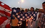 In this Sept. 14, 2012 photo, Libyan followers of Ansar al-Shariah Brigades burn the US flag during a protest in front of the Tibesti Hotel, in Benghazi, Libya. (photo credit: AP Photo / Mohammad Hannon)