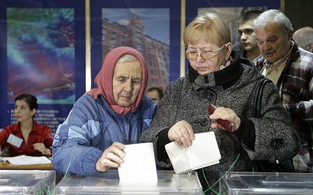 Ukrainians cast their ballots at a polling station in Kiev on Sunday (photo credit: AP/Efrem Lukatsky)