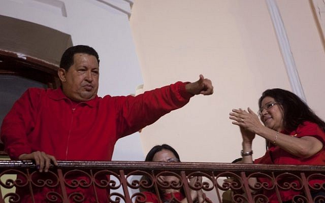 Venezuela's President Hugo Chavez greets his supporters from the Miraflores presidential palace balcony in Caracas, Venezuela, Sunday, Oct. 7, 2012. Chavez won re-election and a new endorsement of his socialist project Sunday, surviving his closest race yet after a bitter campaign against opposition candidate Henrique Capriles.(photo credit: AP Photo/Rodrigo Abd)