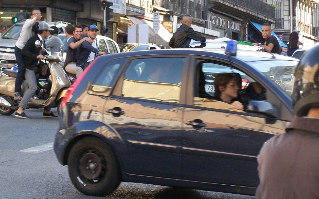 Young Arab residents of Marseille taunt police as they drive recklessly down a central avenue last month. (Cnaan Liphshiz/JTA) Young Arab residents of Marseille taunt police as they drive recklessly down a central avenue last month. (Cnaan Liphshiz/JTA)