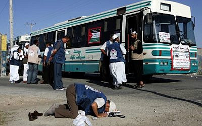 A Palestinian man prays upon arriving at the Rafah border crossing with Egypt en route to Hajj in Mecca, October 14, 2011 (photo credit: Abed Rahim Khatib/Flash 90)