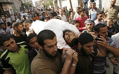 Palestinian mourners carry the body of Mohammed Sheikh, 23, killed by an Israeli air strike on Gaza on Wednesday, Oct. 24 (photo credit: Abed Rahim Khatib/Flash90)