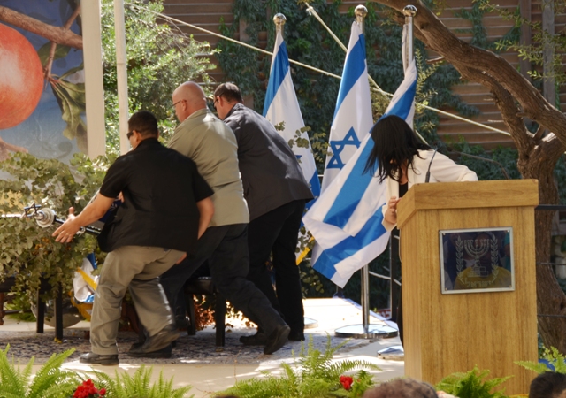 President Peres' bodyguards hurry to his rescue after a sign fell on him Wednesday (photo credit: Sharon Marks Altshul) President Peres' bodyguards hurry to his rescue after a sign fell on him Wednesday (photo credit: Sharon Marks Altshul)