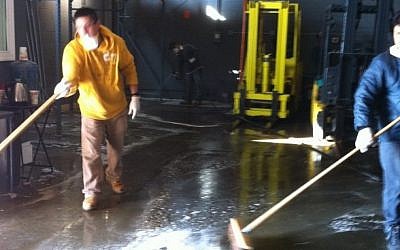 Workers clean and sanitize the warehouse of the kosher cheese firm Anderson International Foods in Jersey City, NJ. (Chavie Lieber/JTA)