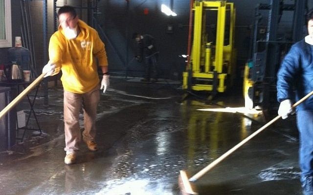 Workers clean and sanitize the warehouse of the kosher cheese firm Anderson International Foods in Jersey City, NJ. (Chavie Lieber/JTA) Workers clean and sanitize the warehouse of the kosher cheese firm Anderson International Foods in Jersey City, NJ. (Chavie Lieber/JTA)