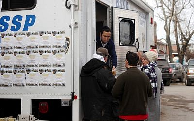 The Jewish volunteer patrol group Shomrim sets up a relief unit in Seagate this week with hot food, drinks and supplies. (Chavie Lieber/JTA)