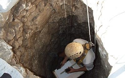 An Israel Antiquities Authority worker descends into a well discovered in the Jezreel Valley in 2012. (photo credit: Yotam Tepper, courtesy of the Israel Antiquities Authority)