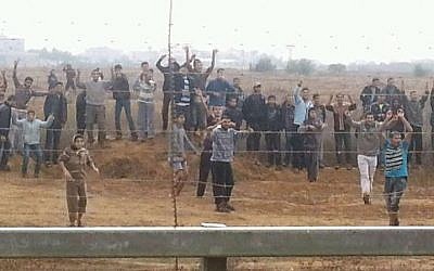 Palestinians in the Gaza Strip hurling rocks and attempting to breach the border fence in November 2012. (photo credit: IDF Spokesperson's Unit)