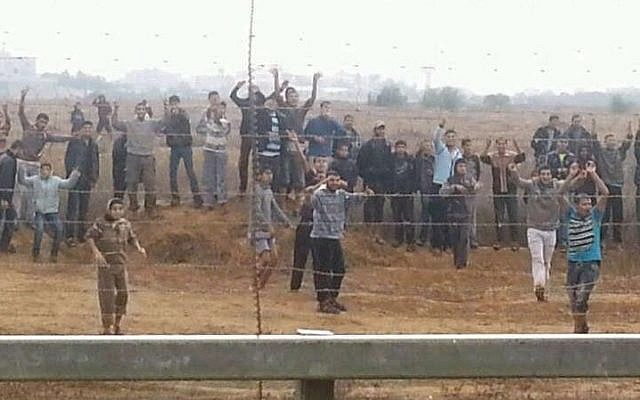 Palestinians in the Gaza Strip hurling rocks and attempting to breach the border fence in November 2012. (photo credit: IDF Spokesperson's Unit) Palestinians in the Gaza Strip hurling rocks and attempting to breach the border fence in November 2012. (photo credit: IDF Spokesperson's Unit)