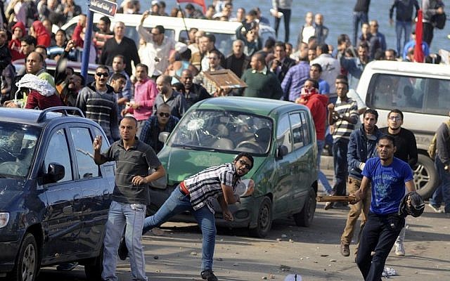 Protesters hurl stones during clashes between supporters and opponents of Egyptian President Mohammed Morsi in Alexandria, Egypt, last Friday (photo credit: AP/Tarek Fawzy)