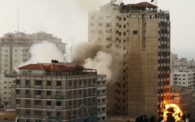 The Gaza media center being hit by an Israeli airstrike on Monday. (photo credit: AP/Hatem Moussa)