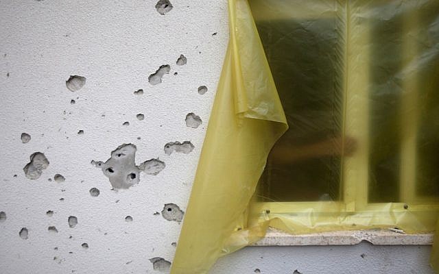 A shrapnel-pocked wall from a mortar that hit near a home in southern Israel on Sunday. (photo credit: AP/Ariel Schalit) A shrapnel-pocked wall from a mortar that hit near a home in southern Israel on Sunday. (photo credit: AP/Ariel Schalit)