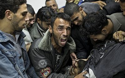 A Palestinian man cries next the body of a dead relative in the morgue of Shifa Hospital in Gaza City on Sunday (photo credit: AP/Bernat Armangue) A Palestinian man cries next the body of a dead relative in the morgue of Shifa Hospital in Gaza City on Sunday (photo credit: AP/Bernat Armangue)