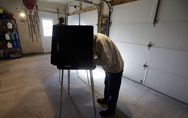 Bob Warhola casts his vote at a polling place inside a residential garage, Tuesday, Nov. 6, 2012, in Forest City, Pa. (Photo credit: Matt Slocum/AP)