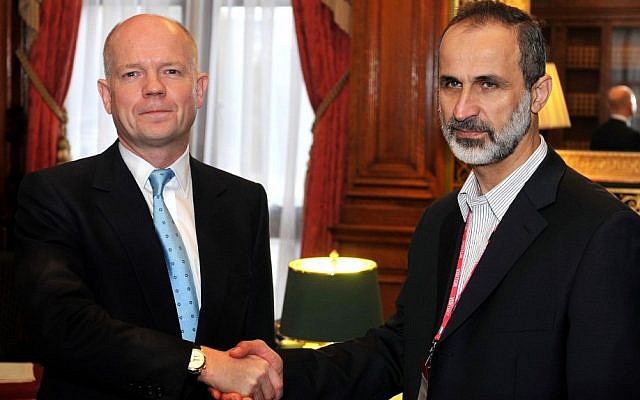 Britain's Foreign Secretary William Hague shakes hands for the cameras with head of the new Syrian National Coalition for Opposition and Revolutionary Forces Mouaz al-Khatib before a meeting on the continuing conflict in Syria on Friday Nov. 16 (photo credit: AP/John Stillwell)