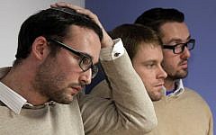 Chaim Levin, left, and Michael Ferguson, right, with his partner Seth Anderson, listen to a news conference in New York on November 27, 2012, describing their claims against the JONAH organization that claims it can 'cure' gay men of their homosexuality. (Photo credit: Richard Drew/AP)
