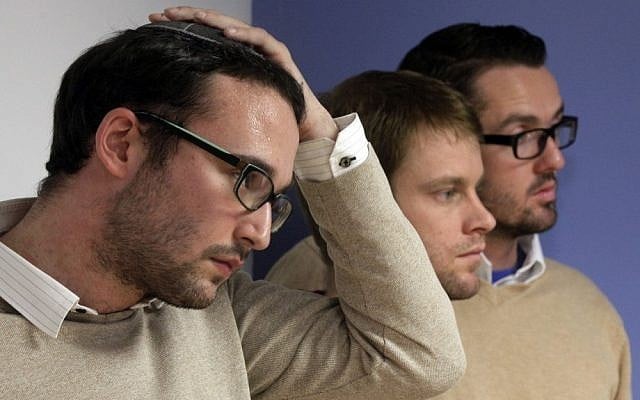 Chaim Levin, left, and Michael Ferguson, right, with his partner Seth Anderson, listen to a news conference in New York on November 27, 2012, describing their claims against the JONAH organization that claims it can 'cure' gay men of their homosexuality. (Photo credit: Richard Drew/AP)
