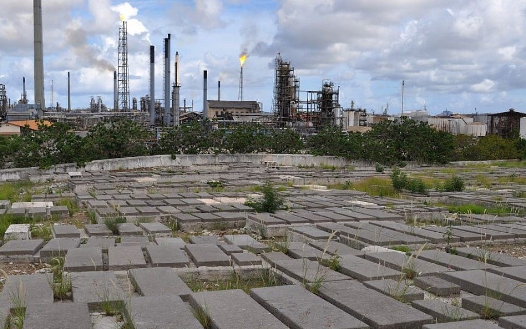 Graves at the Beth Haim cemetery on the outskirts of Willemstad, Curacao, are backdropped by the Isla oil refinery (photo credit: AP/Karen Attiah) Graves at the Beth Haim cemetery on the outskirts of Willemstad, Curacao, are backdropped by the Isla oil refinery (photo credit: AP/Karen Attiah)