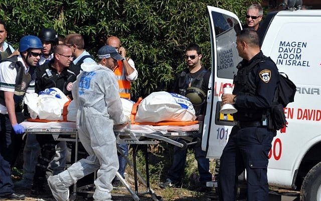 A MDA team carrying one of the victims killed in the attack by Hamas on Kiryat Malachi in southern Israel Thursday (photo credit: David Katz/The Israel Project)