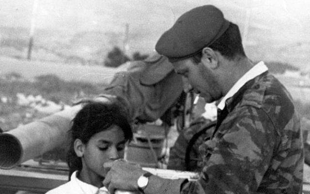 Sgt. Eliezer Sheffer shares water with Basima Shafiq before delivering her home to Jerusalem in June 1967. (Courtesy of Aharon Zukerman/JTA)