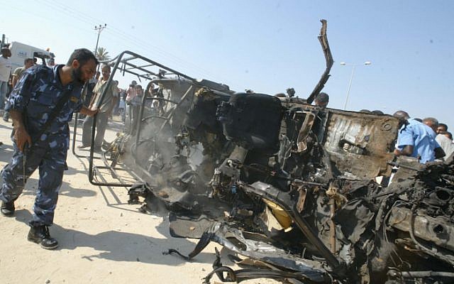 Members of the Hamas executive inspect the destroyed vehicle of Islamic Jihad Movement military leader Omar al-Khati after it was targeted in an Israeli air strike, July 2007 (photo credit: Ahmad Khateib/Flash90) Members of the Hamas executive inspect the destroyed vehicle of Islamic Jihad Movement military leader Omar al-Khati after it was targeted in an Israeli air strike, July 2007 (photo credit: Ahmad Khateib/Flash90)