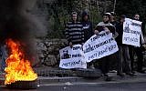 Illustrative: Youth aligned with the settler movement burning tires in Jerusalem in 2012 to protest an outpost demolition. (Abir Sultan/ Flash90)