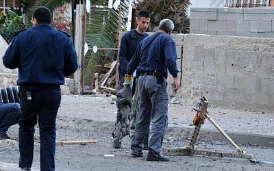 Inspectors at the site of a rocket strike in Beersheba last year. (photo credit: Dudu Grunshpan/Flash90)