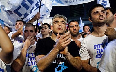 Ex-TV anchor and Yesh Atid party leader Yair Lapid joins some 25,000 people at a rally in Tel Aviv in July urging the government to enact universal draft legislation. (photo credit: Tali Mayer/Flash90)