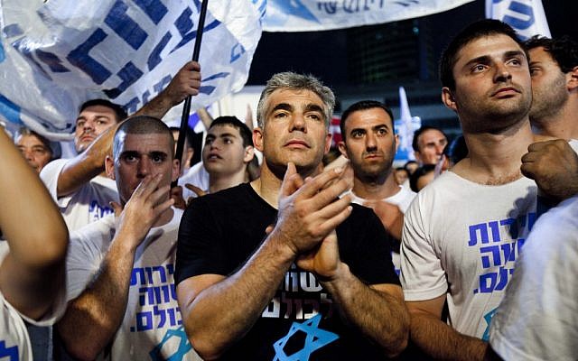 Ex-TV anchor and Yesh Atid party leader Yair Lapid joins some 25,000 people at a rally in Tel Aviv in July urging the government to enact universal draft legislation. (photo credit: Tali Mayer/Flash90) Ex-TV anchor and Yesh Atid party leader Yair Lapid joins some 25,000 people at a rally in Tel Aviv in July urging the government to enact universal draft legislation. (photo credit: Tali Mayer/Flash90)