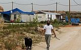A man walking a goat in the settlement of Tsofim on Wednesday. (photo credit: Nati Shohat/Flash90)