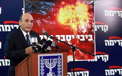 Kadima head Shaul Mofaz presents the party's election campaign slogan, 'Bibi will get us in trouble,' in November (photo credit: Flash90)