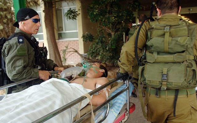 Illustrative: A soldier being brought to Soroka Medical Center in Beersheba after an IED exploded on his patrol on the Gaza border Tuesday, November 6 (photo credit: Dudu Grunshpan/Flash90)