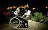 Illustrative: A Filipina caretaker with an elderly Israeli woman on the Tel Aviv boardwalk. (Moshe Shai/Flash90)