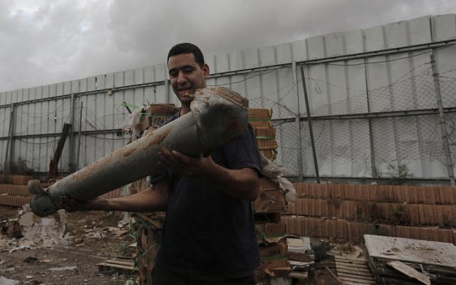 A Netivot resident holds the remains of a rocket, fired by Palestinian militants in Gaza, on Monday, Nov. 12, 2012. (photo credit: Tsafrir Abayov/Flash90) A Netivot resident holds the remains of a rocket, fired by Palestinian militants in Gaza, on Monday, Nov. 12, 2012. (photo credit: Tsafrir Abayov/Flash90)