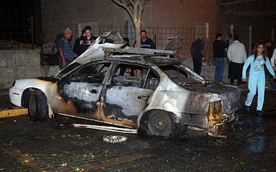 The burnt remains of a car after being hit by a Grad rocket in Beersheba Wednesday. (photo credit: Dudu Grunshpan/Flash90)