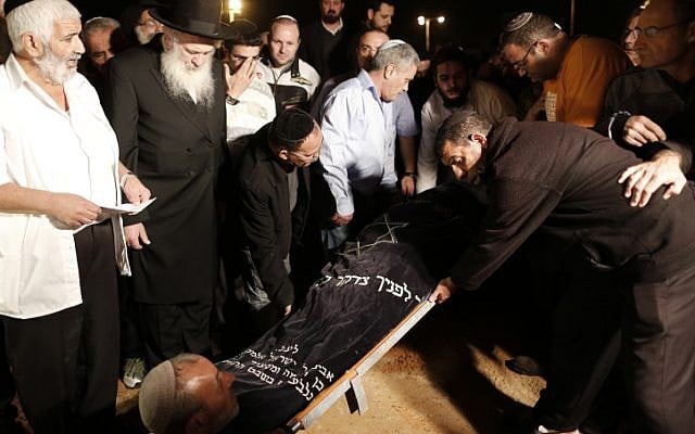 Mourners lower the body of Aaron Smadja, one of the three Israelis killed by a rocket fired from Gaza, during his funeral at a cemetery in the southern city of Kiryat Malachi, Thursday, Nov.15, 2012. (Tsafrir Abayov/Flash90) Mourners lower the body of Aaron Smadja, one of the three Israelis killed by a rocket fired from Gaza, during his funeral at a cemetery in the southern city of Kiryat Malachi, Thursday, Nov.15, 2012. (Tsafrir Abayov/Flash90)