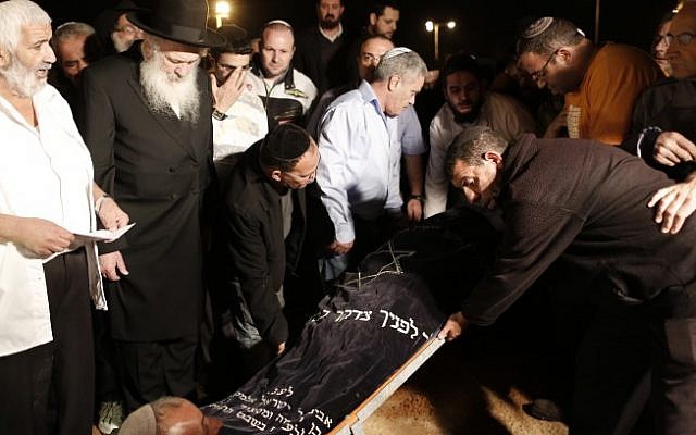 Mourners lower the body of Aharon Smadga, one of the three Israelis killed by a rocket fired from Gaza, during his funeral at a cemetery in the southern city of Kiryat Malachi on Thursday. (photo credit: Tsafrir Abayov/Flash90) Mourners lower the body of Aharon Smadga, one of the three Israelis killed by a rocket fired from Gaza, during his funeral at a cemetery in the southern city of Kiryat Malachi on Thursday. (photo credit: Tsafrir Abayov/Flash90)