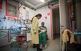 Illustrative: A nurse takes care of an infant in a shelter at Barzilai Hospital as a warning siren sounds for possible incoming rockets in Asheklon on November 15, 2012. (Uri Lenz/Flash90)