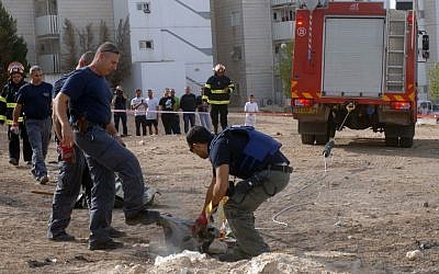 An explosive expert holds the remains of a rocket after it landed in Beersheba, November 16, 2012 (photo credit: Dudu Greenspan/Flash90) An explosive expert holds the remains of a rocket after it landed in Beersheba, November 16, 2012 (photo credit: Dudu Greenspan/Flash90)