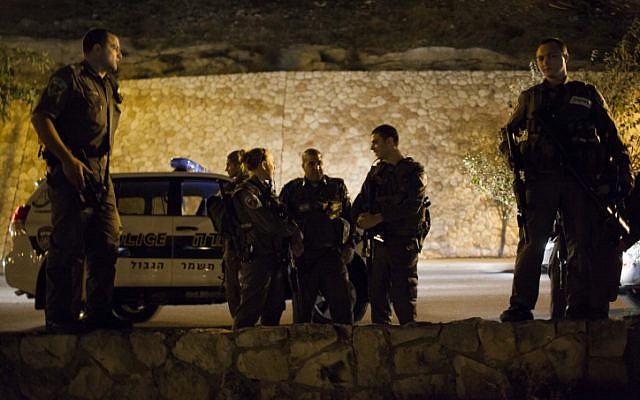 Border Police officers search for the remains of a missile that was shot from the Gaza Strip by Hamas and landed near the settlement bloc of Gush Etzion. (photo credit: Yonatan Sindel/Flash90)