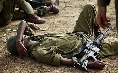 A soldier rests during training exercises on Saturday. (photo credit: Edi Israel/Flash90)